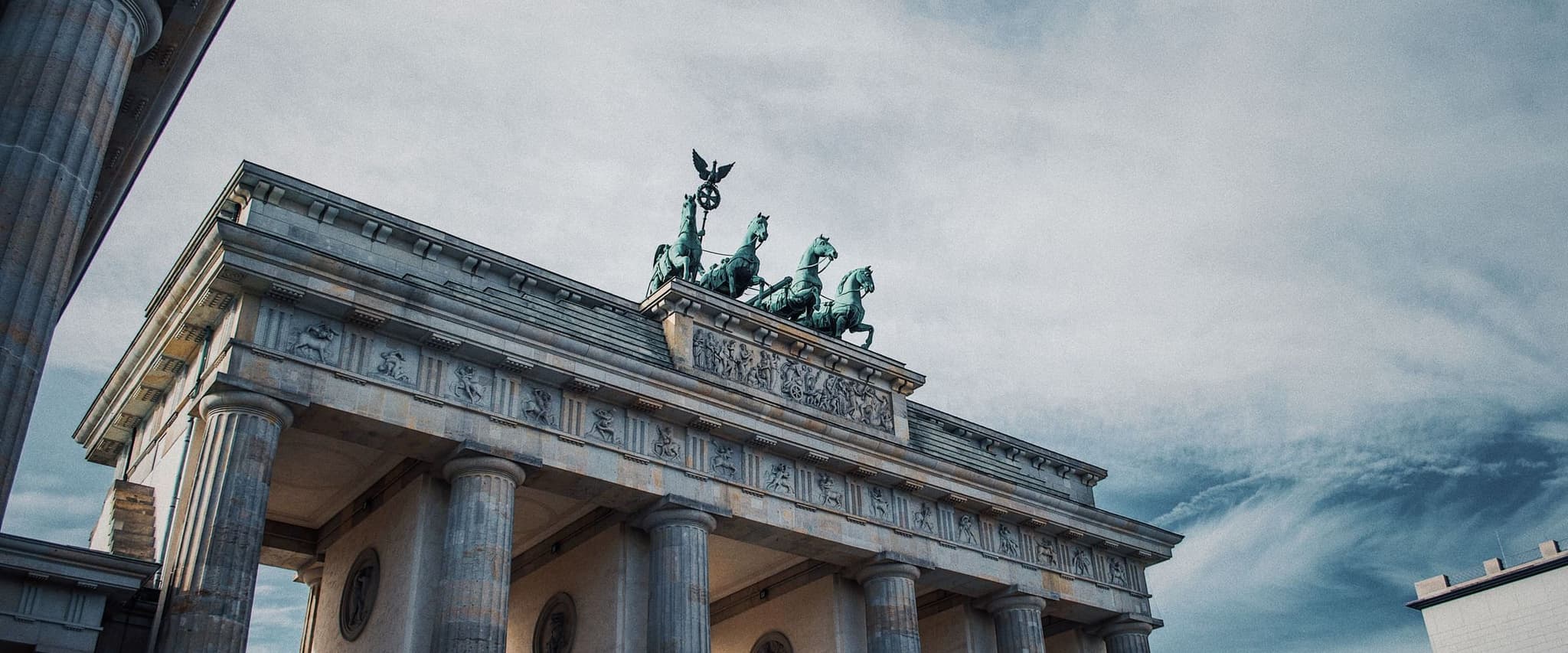 Brandenburg Gate in Berlin under a dramatic sky